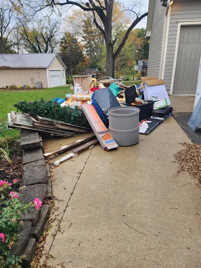 Dumpster being loaded with debris for Commercial Dumpster Rental in Heber Springs